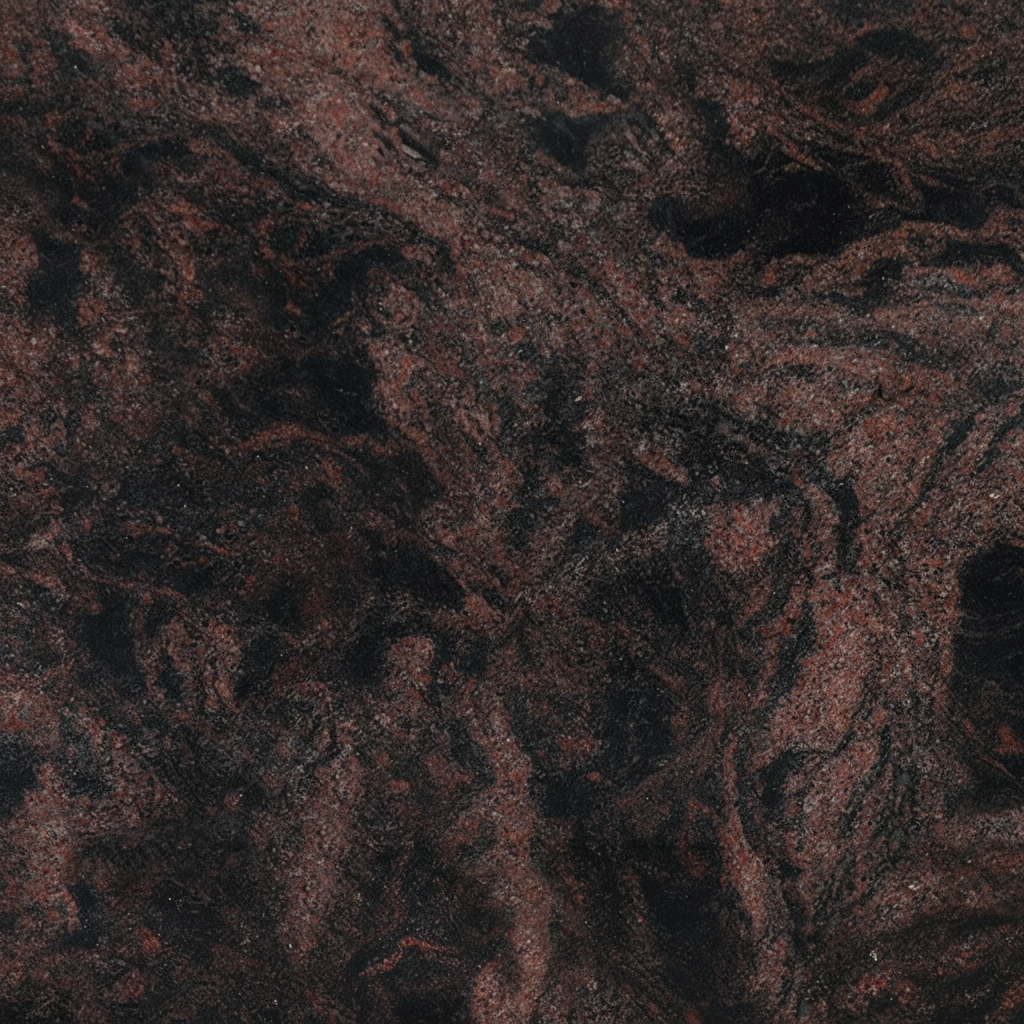 A close-up image of Cosmic Black granite, showcasing its dark, near-black coloration with dynamic reddish-brown veins and specks creating a swirling, natural pattern. This intricate stone texture is often chosen for its durability and unique aesthetic in memorial and headstone designs.