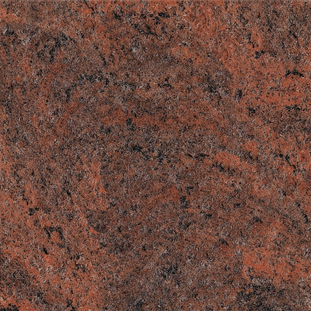 A close-up image of red granite, showcasing its natural rough texture and speckled appearance with deep reddish-brown and black mineral deposits. This durable stone is often used for memorials and headstones, embodying strength and timeless beauty.
